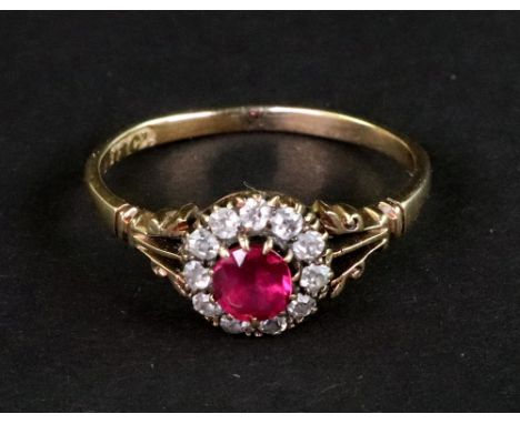 An early 20th century gold, ruby and diamond cluster ring, centred with a round mixed-cut ruby within a small old-cut diamond