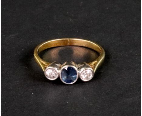 A sapphire and diamond three stone ring, the central round mixed-cut sapphire between old-cut diamonds each approximately 0.2