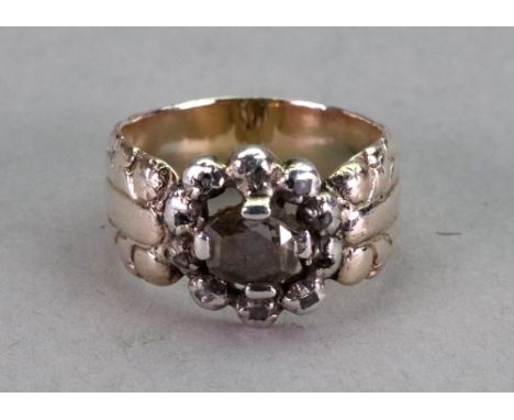 A 19th century diamond ring, the central rose cut diamond in claw settings within a surround of ten rose cut diamonds with a 