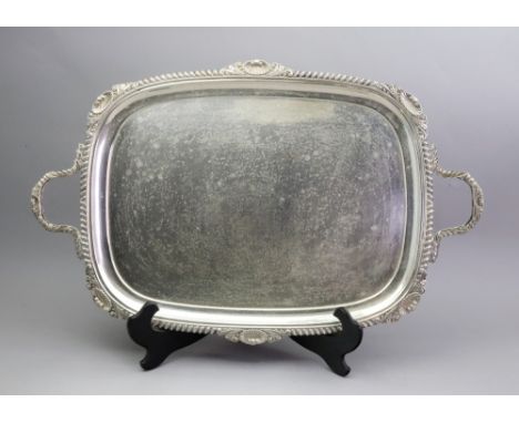 A George IV style silver two handled tea tray, William Hutton & Sons, London 1908, with shell, leaf scroll and gadroon border