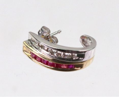 A ruby and diamond two colour scroll earring, detailed '14k' set with calibre and circular cut stones.