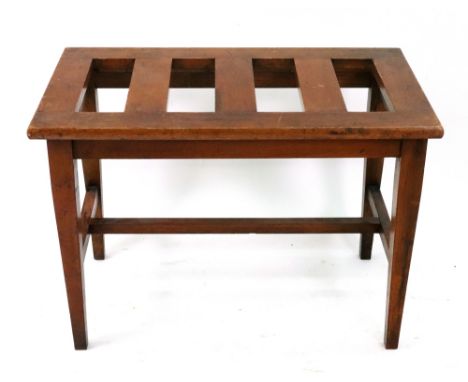 An Edwardian walnut luggage rack, with slatted rectangular top, on square tapered legs united by stretchers, 66cm wide x 40cm