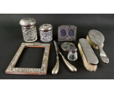 A Victorian silver mounted cylindrical cut glass dressing table jar, Birmingham 1897, the pull-off cover leafy scroll and flo