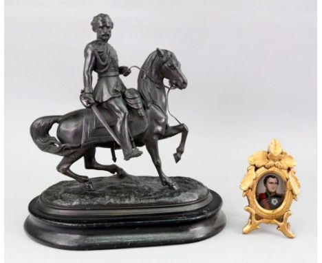 A Victorian bronzed speltar figure of a cavalry officer on horseback, oval naturalistic base and ebonised plinth, 23.5cm wide