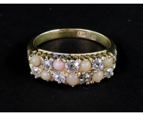 An early 20th century gold, diamond and coral 'chequer-board' ring, alternately set with seven small old-cut diamonds and sev