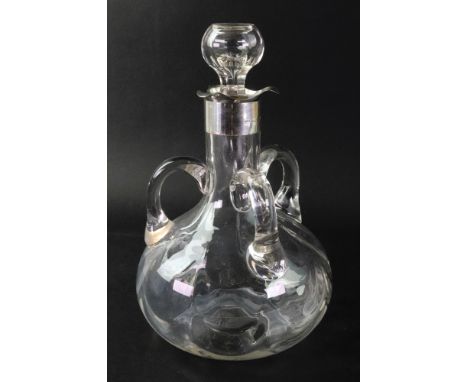 An Edwardian silver mounted glass three handled decanter, Chester 1902, 21.5cm high.