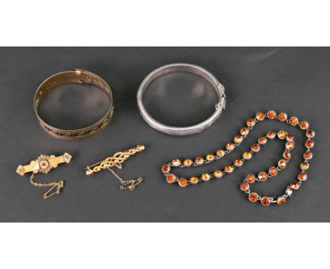 A collection of jewellery comprising; an early 20th century rose gold entwined knot and bead brooch, stamped '9ct' (base meta