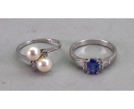 A white gold, tanzanite and diamond ring, the central oval cut claw set tanzanite flanked on each side with two round brillia
