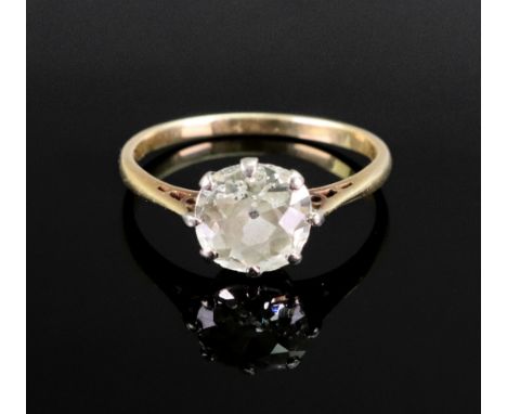 An early 20th century gold and diamond solitaire ring, the off-round cushion-shaped old-cut stone approximately 1.10cts, claw