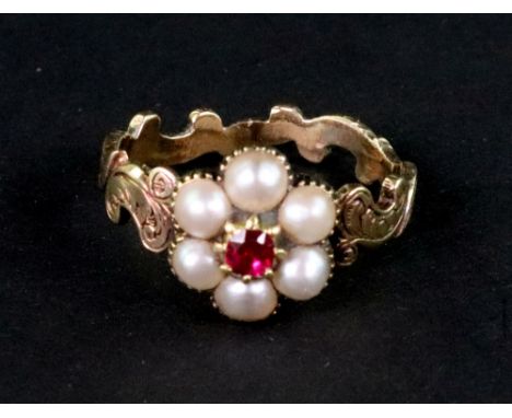 A Victorian gold, ruby and pearl cluster memorial ring, the head centred with a small cushion-shaped ruby within a half-pearl