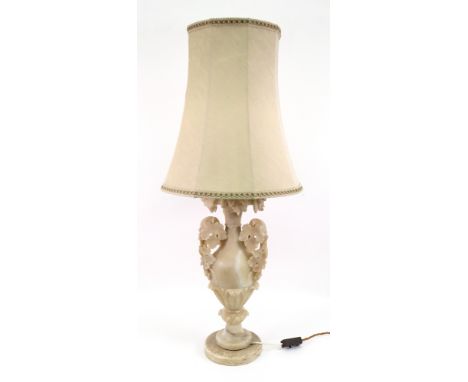 A Victorian alabaster baluster shape vase, adapted as a table lamp, carved with fruiting vines, on a lotus carved pillar and 