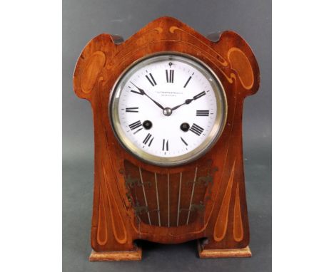 Ollivant &amp; Botsford Manchester; an Art Nouveau mahogany and walnut mantel clock, of shaped outline, boxwood and pewter in