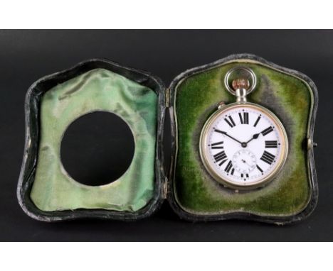 A silver mounted easel watch case, Chester 1910, of shaped arched outline, containing a Goliath watch in plated case, the whi