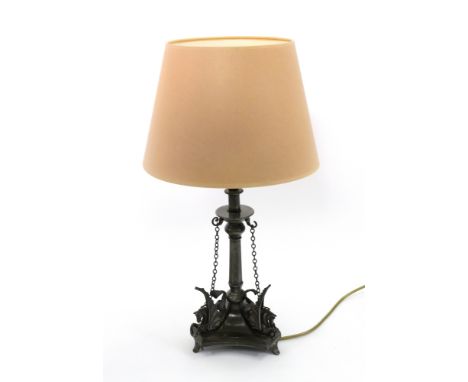 A Victorian electroplate table lamp, adapted from a tazza, hung with chains, the concave sided spreading triangular base surm