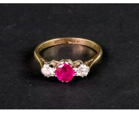 An early 20th century gold, ruby and diamond three stone ring, the central oval mixed-cut ruby approx. 0.45cts, between old-c