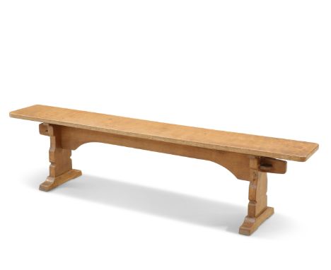 ROBERT THOMPSON OF KILBURN, A MOUSEMAN OAK BENCH, the 6-foot adzed top raised on a trestle base, with carved mouse signature.