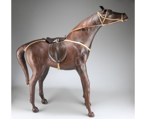 A LARGE VINTAGE LEATHER-COVERED MODEL OF A HORSE, modelled standing with head raised. 72cm high