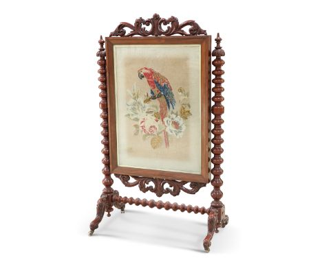 A VICTORIAN LARGE MAHOGANY AND NEEDLEWORK FIRESCREEN, the boldly bobbin-turned stand suspending a large rectangular banner de