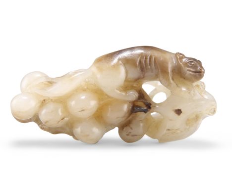 A CHINESE JADE CARVING OF A SQUIRREL AND GRAPES GROUP, depicting a squirrel climbing upon a bunch of grapes, a smaller squirr