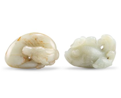 TWO CHINESE JADE CARVINGS, including A SLEEPING DOG, 2cm by 6cm by 4cm; and A FISH AND LOTUS GROUP, 4cm by 6cm. (2)CONDITION 
