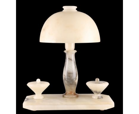 AN ART DECO PERIOD ALABASTER DESK LAMP, the lamp with mushroom shade, supported on a plinth base with twin inkwells. 36cm hig