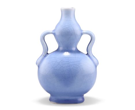 A CHINESE BLUE-GLAZED GOURD VASE, of compressed form with twin handles, bears underglaze blue seal mark. 16.5cm highCONDITION