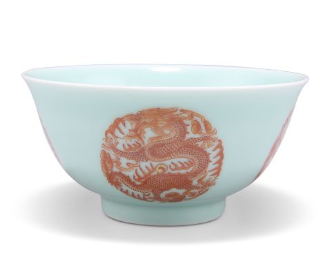 A CHINESE DRAGON BOWL, circular, iron red painted with four dragon roundels to the exterior and one to the interior, bears un