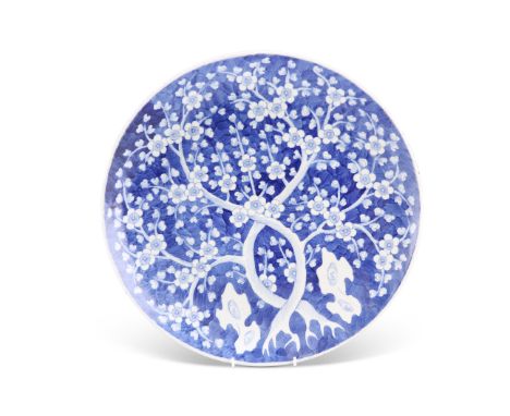 A 19TH CENTURY CHINESE BLUE AND WHITE CHARGER, circular, painted with prunus, bears underglaze blue mark. 41cm diameterCONDIT