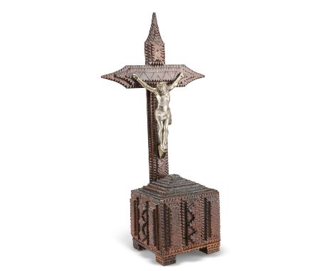 A 19TH CENTURY TRAMP ART CRUCIFIX, with affixed white metal figure of Christ, to a square base and raised on square supports.