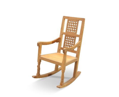 ROBERT THOMPSON OF KILBURN, A MOUSEMAN OAK ROCKING CHAIR, with characteristic lattice back and faceted baluster fore legs, wi