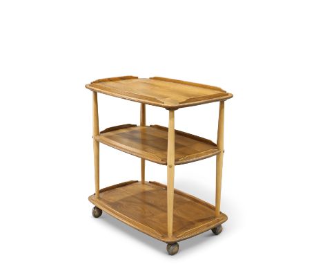 AN ERCOL LIGHT ELM TEA TROLLEY, the three rounded rectangular tiers supported on reverse tapering columns, moving on castors.