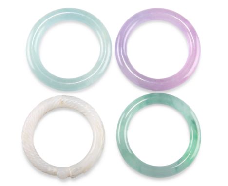 FOUR JADE BANGLES, including A WHITE JADE DRAGON BANGLE, carved depicting a dragon with a spiral fluted body chasing its tail