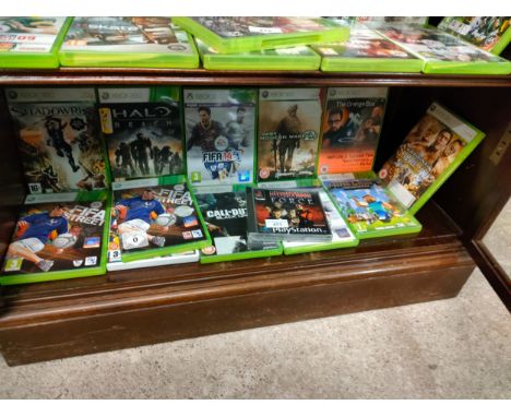 Shelf of Xbox 360 games . 