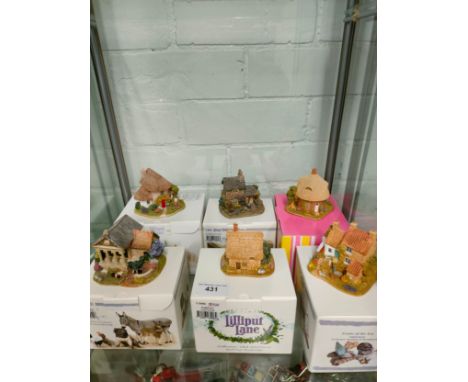 Shelf of Lilliput lane s with boxes . 