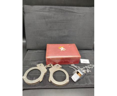 Set of Hiatt hand cuffs , old police acme thunder whistle with Glasgow foliage together with vintage cigarette box . 