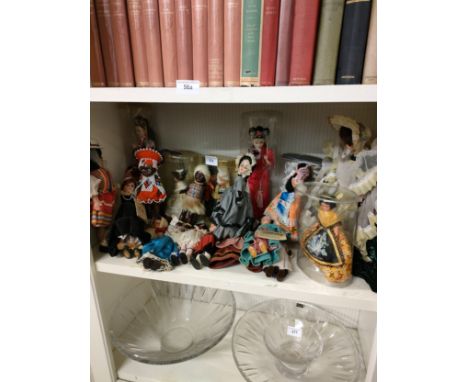 Shelf of vintage dolls of the world etc . 