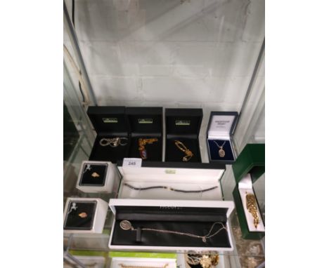 Shelf of boxed jewellery includes silver . 