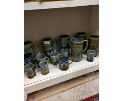 Shelf of Irish wade pottery tankards etc. 