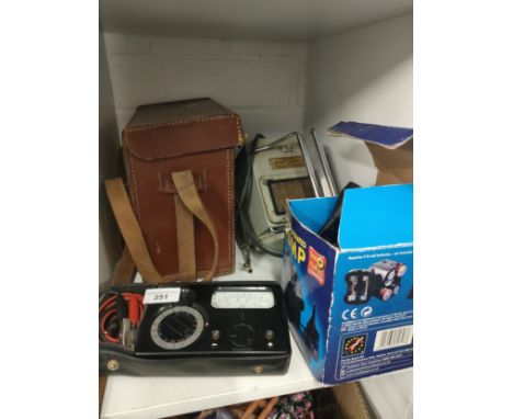 Vintage insulation tester , vintage volt meter together with boxed pump . 