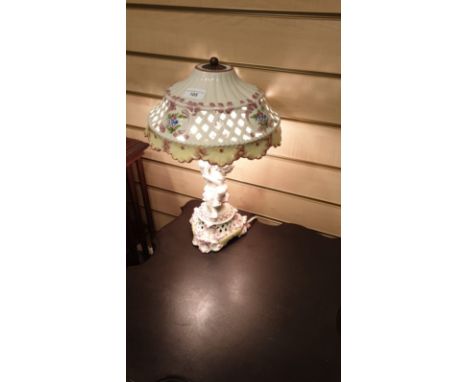 Beautiful  Porcelain  Lamp With Cherub Base rising To  Hand Painted pierced  Porcelain  Shade Gorgeous  lamp . 