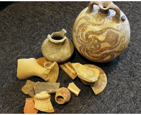 A collection of Mycenaean style pottery sherds and fragments, together with a replica Mycenaean pottery two handled flask. 