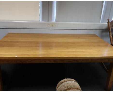 A large French light oak dining table, with seven chairs, 121cm x 214cm.