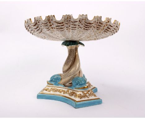 A 19th century Royal Worcester porcelain tazza. The shell bowl supported on triform dolphin support, with puce mark to base. 