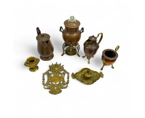 A collection of copper and brass wares, comprising assorted Arts & Crafts style pieces, a hot water jug, two matching copper 
