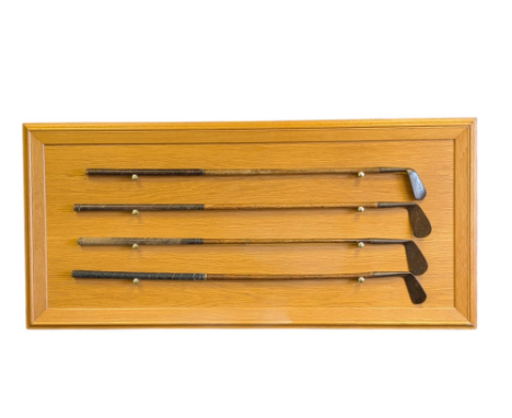 Four vintage hickory shafted Golf clubs, together with a wall mounted rack, comprising a Spalding Kro Flite, a lefthanded Fai