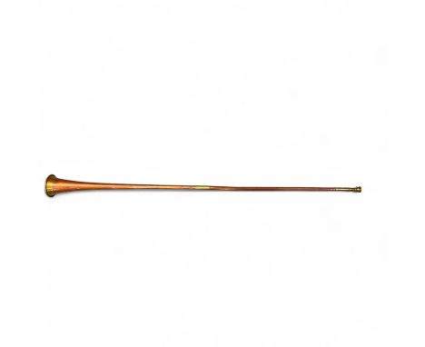 A brass and copper hunting horn, 130cm long.