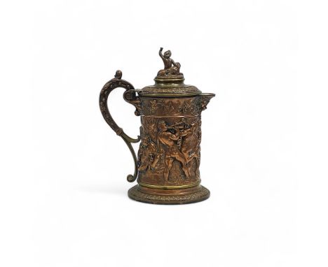 A 19th century Bacchanalian electrotype copper and brass beer jug, the figural finial depicting a putto and lion, over a mask