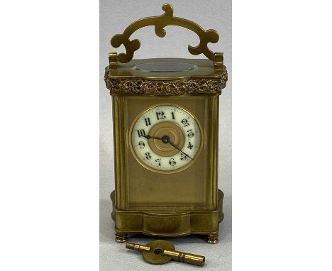 VINTAGE FRENCH BRASS CARRIAGE CLOCK with shaped detail to the upper and lower case and the swing handle on turned corner feet