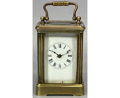EARLY 20TH CENTURY MINIATURE CARRIAGE CLOCK, single train within a brass case with bevelled glass panels and swing handle, 10