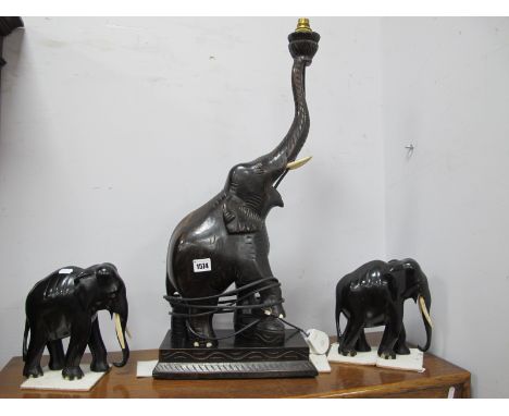 Ebonised Table Lamp as an Elephant, 66cm high excluding fittings and pair of elephant ornaments. (3)